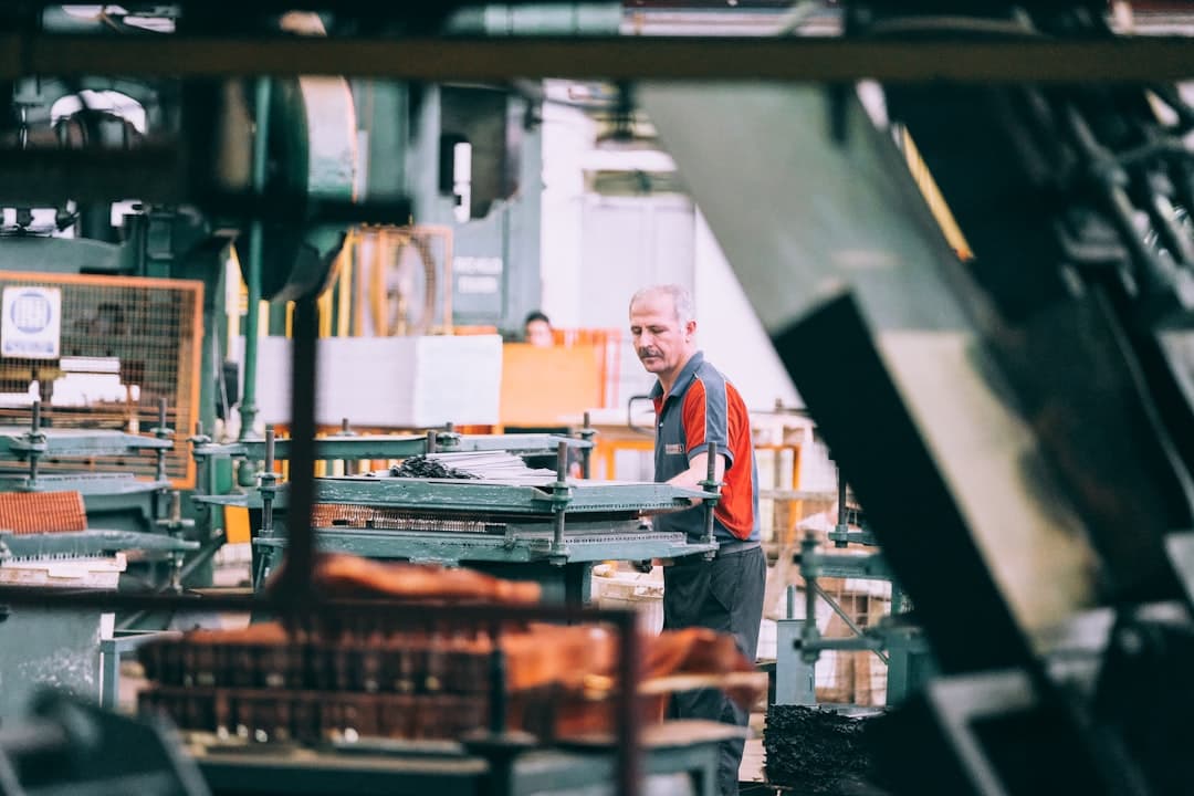 A man in a factory operating industrial machinery